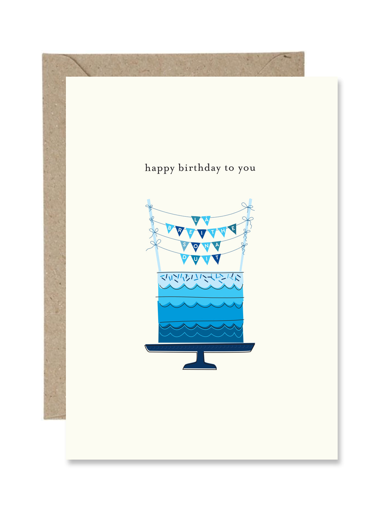 Bilingual greeting card with blue birthday cake illustration and 'happy birthday to you' text. Cake topper says Lá Breithe Sona Duit.